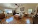 Spacious main bedroom with hardwood floors, and a ceiling fan at 5480 Lincolnwood Ct, Pahrump, NV 89061