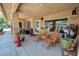 Covered patio with seating, plants, and lovely stone floors at 5480 Lincolnwood Ct, Pahrump, NV 89061