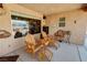 Covered patio with comfortable seating area, ideal for outdoor relaxation at 5480 Lincolnwood Ct, Pahrump, NV 89061