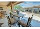 Inviting covered patio with outdoor dining set and cozy seating area perfect for relaxing and entertaining at 5480 Lincolnwood Ct, Pahrump, NV 89061