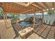 Backyard pond with stone waterfall and pergola offers serene outdoor retreat with built-in benches at 5480 Lincolnwood Ct, Pahrump, NV 89061