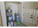 A utility closet area features a water heater and water softener setup, next to a door at 5480 Lincolnwood Ct, Pahrump, NV 89061