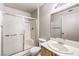 Well-lit bathroom with white shower, glass doors, a sink vanity, and a modern toilet at 5710 E Tropicana Ave # 1114, Las Vegas, NV 89122
