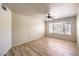 Bedroom has laminate wood flooring, large window, and ceiling fan at 5710 E Tropicana Ave # 1114, Las Vegas, NV 89122