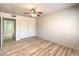 Bright bedroom with light wood-look flooring, closet, and ceiling fan for a comfortable and stylish space at 5710 E Tropicana Ave # 1114, Las Vegas, NV 89122