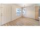 Bright dining area featuring modern floors, an entry door, and view of the kitchen at 5710 E Tropicana Ave # 1114, Las Vegas, NV 89122