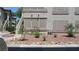 Exterior of building featuring a staircase, well-kept desert landscaping, and covered windows at 5710 E Tropicana Ave # 1114, Las Vegas, NV 89122