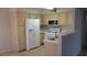 Spacious kitchen featuring a white refrigerator and gas range at 5710 E Tropicana Ave # 1114, Las Vegas, NV 89122