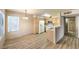 Open kitchen concept with new appliances, wood cabinets, and laminate flooring throughout at 5710 E Tropicana Ave # 1114, Las Vegas, NV 89122