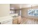 Open kitchen/dining area with laminate wood floors, bright lighting, and stainless steel sink at 5710 E Tropicana Ave # 1114, Las Vegas, NV 89122