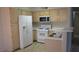 Kitchen with white appliances and light wood cabinets at 5710 E Tropicana Ave # 1114, Las Vegas, NV 89122
