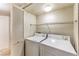 Functional laundry room featuring a washer, dryer, and shelving for convenient storage at 5710 E Tropicana Ave # 1114, Las Vegas, NV 89122