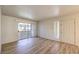 Bright living room with modern flooring, a sliding glass door to balcony, and new paint at 5710 E Tropicana Ave # 1114, Las Vegas, NV 89122