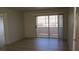 Spacious living room with sliding glass doors and modern flooring at 5710 E Tropicana Ave # 1114, Las Vegas, NV 89122