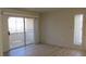 Bright living room featuring sliding glass doors and wood-look flooring at 5710 E Tropicana Ave # 1114, Las Vegas, NV 89122