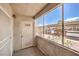 Cozy screened-in patio with views of the parking area and landscaping, ideal for outdoor relaxation at 5710 E Tropicana Ave # 1114, Las Vegas, NV 89122