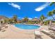 Enjoy the community pool with comfortable lounge chairs under the sunny blue sky at 5710 E Tropicana Ave # 1114, Las Vegas, NV 89122