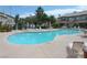 Large community pool with lounge chairs and umbrellas at 5710 E Tropicana Ave # 1114, Las Vegas, NV 89122