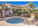 Relax in the community hot tub, surrounded by lush landscaping and a lounge chair at 5710 E Tropicana Ave # 1114, Las Vegas, NV 89122