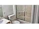 Bathroom featuring a toilet and a tub with a sliding glass door at 5710 E Tropicana Ave # 2178, Las Vegas, NV 89122