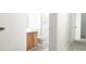 Bathroom featuring a wood vanity with a white toilet and shower at 5710 E Tropicana Ave # 2178, Las Vegas, NV 89122