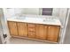 Bathroom with double sinks, wood cabinets, and light-colored countertop at 5710 E Tropicana Ave # 2178, Las Vegas, NV 89122