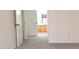 Bright bedroom with gray carpet leading to an ensuite bathroom with wood cabinetry at 5710 E Tropicana Ave # 2178, Las Vegas, NV 89122