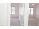 Bright bedroom with two windows and a ceiling fan with gray carpet at 5710 E Tropicana Ave # 2178, Las Vegas, NV 89122