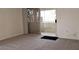 Bedroom featuring gray carpet with sliding glass doors leading to a balcony at 5710 E Tropicana Ave # 2178, Las Vegas, NV 89122