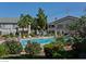 Community pool surrounded by lush greenery and lounge chairs, creating a relaxing outdoor oasis at 5710 E Tropicana Ave # 2178, Las Vegas, NV 89122