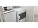 Laundry room with a white washer and dryer and storage at 5710 E Tropicana Ave # 2178, Las Vegas, NV 89122