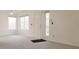 Bright living room with light gray carpeting, large windows, and a view of the balcony at 5710 E Tropicana Ave # 2178, Las Vegas, NV 89122