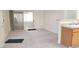 Living room with gray carpet with a kitchenette and sliding glass doors to the balcony at 5710 E Tropicana Ave # 2178, Las Vegas, NV 89122