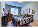 Cozy bedroom featuring a wooden dresser, comfortable bed and stylish Southwestern-inspired decor at 5854 Olivine Falls Ave, Las Vegas, NV 89130