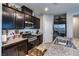 Stylish kitchen featuring granite countertops, stainless steel appliances and dark wood cabinets at 5854 Olivine Falls Ave, Las Vegas, NV 89130
