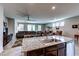 Open floor plan with kitchen island, comfortable living room and dining area with lots of natural light at 5854 Olivine Falls Ave, Las Vegas, NV 89130