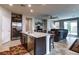 Open floor plan flows from the kitchen island to the comfortable living room and dining area at 5854 Olivine Falls Ave, Las Vegas, NV 89130
