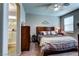 Relaxing main bedroom featuring a ceiling fan, comfortable bedding and ensuite bathroom at 5854 Olivine Falls Ave, Las Vegas, NV 89130
