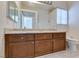 Bathroom featuring granite countertops, double sinks, and wood cabinets at 6 High Sierra Dr, Henderson, NV 89074