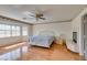 Bedroom with wood-look flooring, a ceiling fan, a fireplace, and a large window at 6 High Sierra Dr, Henderson, NV 89074