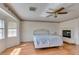 Bedroom with wood-look flooring, a ceiling fan, and a fireplace at 6 High Sierra Dr, Henderson, NV 89074