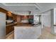 Kitchen with stylish granite counters, wood cabinets, recessed lighting and light tile floors at 6 High Sierra Dr, Henderson, NV 89074