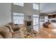 Bright, open living room with a fireplace, large windows, and views into the kitchen and backyard at 6 High Sierra Dr, Henderson, NV 89074