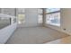 Bright, open-concept living area featuring neutral tones, plush carpeting, and large windows for natural light at 6 High Sierra Dr, Henderson, NV 89074