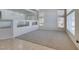 Bright, open-concept living area featuring neutral tones, plush carpeting, and large windows for natural light at 6 High Sierra Dr, Henderson, NV 89074