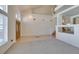 Bright, open-concept living area featuring neutral tones, plush carpeting, and large windows for natural light at 6 High Sierra Dr, Henderson, NV 89074