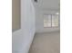 Open floor plan with neutral carpet, large windows, and updated lighting fixtures at 6 High Sierra Dr, Henderson, NV 89074