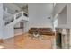 Open living room features wood floors, fireplace, and staircase access to upper level at 6 High Sierra Dr, Henderson, NV 89074