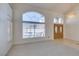 Bright, open-concept living area featuring neutral tones, plush carpeting, and large windows for natural light at 6 High Sierra Dr, Henderson, NV 89074