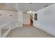 Open floor plan with neutral carpet, view of staircase, and updated lighting at 6 High Sierra Dr, Henderson, NV 89074